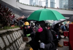 A demonstrator prepares to throw a brick at police during a protest in Hong Kong, Aug. 31, 2019.