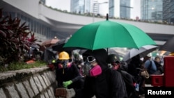 A demonstrator prepares to throw a brick at police during a protest in Hong Kong, Aug. 31, 2019.