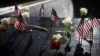 Flowers and flags are left at the south reflecting pool during a ceremony marking the 23rd anniversary of the Sept. 11, 2001, attacks at the 9/11 Memorial and Museum in New York on Sept. 11, 2024.