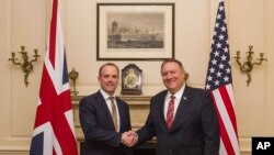 FILE - UK Foreign Secretary Dominic Raab shakes hands with US Secretary of State Mike Pompeo in London, Jan. 29, 2020. 