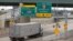FILE - A commmercial truck exits the highway for the Ambassador Bridge to Canada, in Detroit, Michigan, Aug. 30, 2018. 