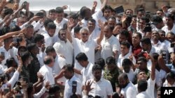 Sri Lanka's newly elected president Gotabaya Rajapaksa, center, greets people as he leaves after the swearing in ceremony held at the 140 B.C Ruwanweli Seya Buddhist temple in ancient kingdom of Anuradhapura in north central Sri Lanka, Nov. 18, 2019.