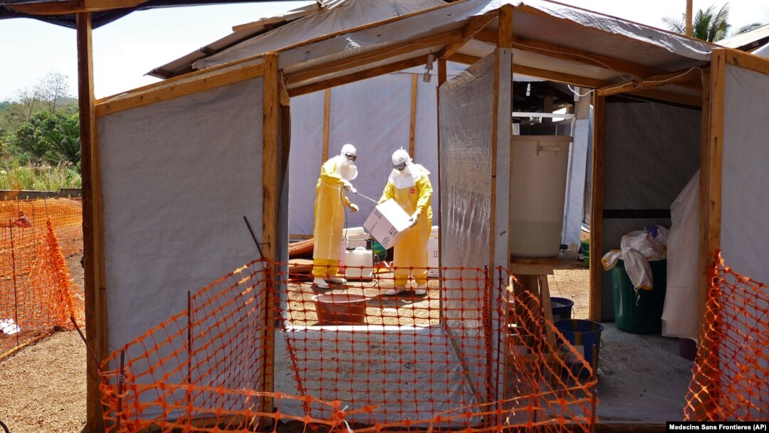 FILE - Health care workers from Medecins Sans Frontieres prepare isolation and treatment areas for their Ebola, hemorrhagic fever operations, in Gueckedou, Guinea. 