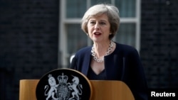 FILE - British Prime Minister Theresa May, shown speaking to reporters in London, July 13, 2016, says suspending parts of the convention during conflict would allow British troops to take "difficult decisions" on the battlefield without fear of having dubious legal claims filed against them later.