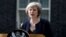 FILE - British Prime Minister Theresa May speaks to reporters outside No. 10 Downing Street in London, July 13, 2016.