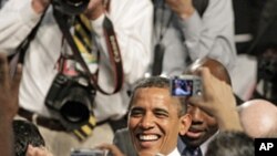 President Barack Obama shakes hands and poses for photos after speaking about the American Jobs Act at Eastfield College in Mesquite, Texas, Oct. 4, 2011