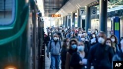 Commuters crowd Cadorna train station in Milan, Italy, May 4, 2020.