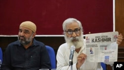 Indian activist and education reformer Sandeep Pandey, right, addresses a press conference in New Delhi, India, Oct. 5, 2019. Pandey and a U.S. senator were barred from Indian-administered Kashmir, where at least 10 people were hurt in a grenade blast. 