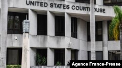 A security guard walks past the C. Clyde Atkins US Federal Courthouse in Miami, Florida, on Jan. 20, 2022, during the first court appearance of Rodolphe Jaar.