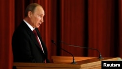 Russian President Vladimir Putin delivers a speech during a meeting with Russian ambassadors, envoys and diplomats at the Foreign Ministry headquarters in Moscow, July 1, 2014.