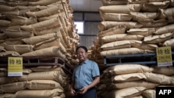 FILE - Hebei Dawu Agricultural and Animal Husbandry Group founder Sun Dawu stands at a feed warehouse in Hebei, outside Beijing, Sept. 24, 2019.