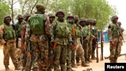 Soldiers stand during a parade in Baga village on the outskirts of Maiduguri, in the north-eastern state of Borno, Nigeria, May 13, 2013.