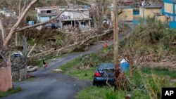 Jonathan Aponte walks with a gas can up the road to his home in the aftermath of Hurricane Maria, in Yabucoa, Puerto Rico, Sept. 26, 2017.Puerto Rico Hurricane Maria