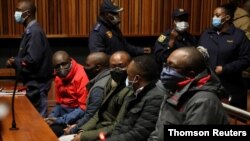 Some of the eight suspects in the VBS Mutual Bank fraud case appear at the Palm Ridge Regional Court in Alberton, South Africa, June 18, 2020.