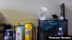 FILE - Lysol and hand sanitizer are placed in dorms at Syracuse University.