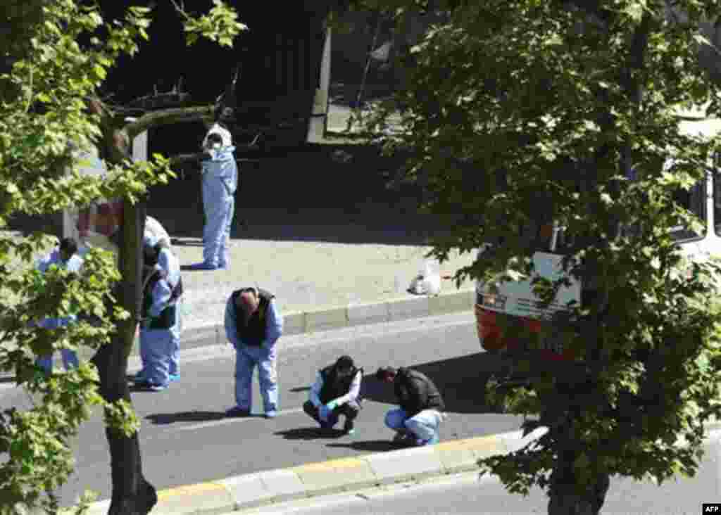 Security members and forensic experts work at the scene after a bomb exploded at a bus stop during rush hour in Istanbul, Turkey, Thursday, May 26, 2011. A bomb placed on a bicycle near a bus stop exploded during morning rush hour in Istanbul on Thursday,