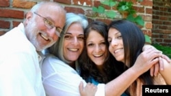 U.S. aid contractor Alan Gross and his wife Judy (2nd L) pose with their daughters during a Friday Shabbat dinner at a friend's home in the Washington area, in this undated family photograph released on October 23, 2010.