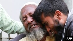 Relatives react outside the burn unit of Dhaka Medical College Hospital following a deadly fire at a plastic factory in Dhaka on December 12, 2019.