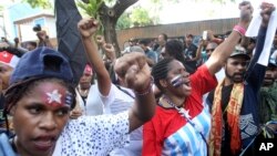 Papuan activists shout slogans at a rally commemorating the 57th anniversary of the failed efforts by Papuan tribal chiefs to declare independence from Dutch colonial rule, in Surabaya, Indonesia, Saturday, Dec. 1, 2018.