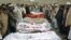 Villagers stand around the bodies of girls who were killed by an explosion in Jalalabad, Afghanistan, December 17, 2012. 