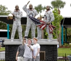 Guests take a selfie photo in front of a new statue of the the Apollo 11 astronauts, from left, Michael Collins, Neil Armstrong and Buzz Aldrin at the Kennedy Space Center Visitor Complex Thursday, July 18, 2019, in Cape Canaveral, Florida.