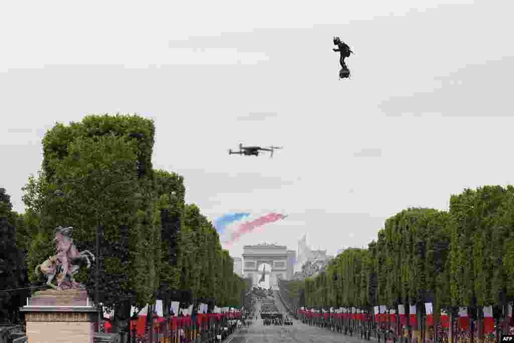 Zapata CEO Franky Zapata flies a jet-powered hoverboard or "Flyboard" during the Bastille Day military parade down the Champs-Elysees avenue in Paris, France, July 14, 2019.