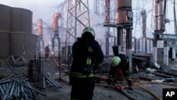 Firefighters extinguish a blaze at an electricity facility after a Russian attack in Kharkiv, Ukraine, on March 22, 2024.