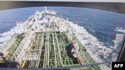 A CCTV footage of the Hankuk Chemi is displayed on a screen as a boat of Iran's Revolutionary Guards is seen in red circle on the screen at the tanker's owner company DM Shipping, in Busan, Jan. 4, 2021. ((Photo by - / YONHAP / AFP) 