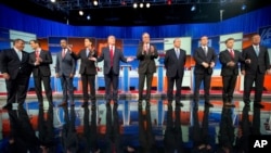 Republican presidential candidates, from left, Chris Christie, Marco Rubio, Ben Carson, Scott Walker, Donald Trump, Jeb Bush, Mike Huckabee, Ted Cruz, Rand Paul and John Kasich take the stage for their debate at Quicken Loans Arena in Cleveland, Aug. 6, 2015. (AP Photo/Andrew Harnik)