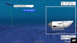 In a still from from an animation provided by the U.S. Coast Guard an illustration of the Titan submersible is shown near the floor of the Atlantic Ocean, as June 18, 2023, communications between the sub and a support vessel are represented at left.