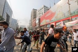 Aktivis Partai Nasionalis Bangladesh berlari setelah bentrok dengan polisi saat protes di Dhaka, Bangladesh, Sabtu, 28 Oktober 2023 (Foto: AP)