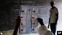 FILE - Election officials start counting the ballots after polls closed in the presidential elections in Bujumbura, Burundi, July 21, 2015. 