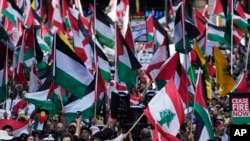 People march on the street as Pro-Palestinian supporters rally in Sydney, Oct. 6, 2024.