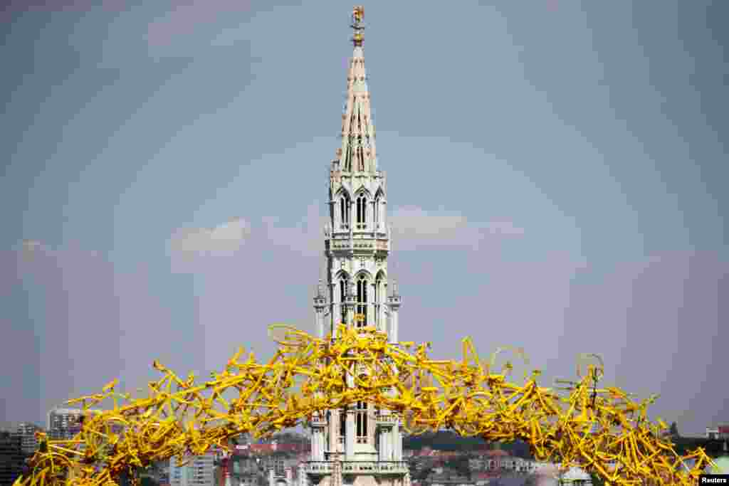 An arch of yellow bicycles is seen in front of Brussels Town Hall, Belgium, during the second stage of the Tour de France cycling race.
