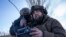 A Ukrainian serviceman aka Zakhar, right and commander of a unit aka Kurt, look on a screen of a drone remote control during fighting, at the frontline in Donetsk region, Ukraine, Feb. 13, 2023. 