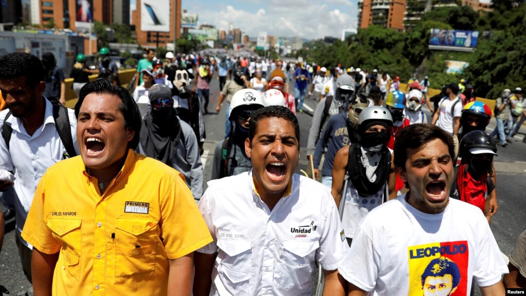 FILE - Deputies of the opposition parties Carlos Paparoni, left, Jose Manuel Olivares, center, and Juan Mejia shout slogans during a march to state ombudsman's office in Caracas, Venezuela, May 29, 2017.