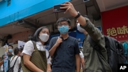 Hong Kong activist Joshua Wong poses for a photo with supporters after attending an activity for the upcoming Legislative Council elections in Hong Kong on June 20, 2020. 