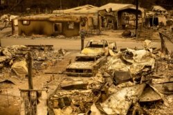Scorched homes and vehicles fill Spanish Flat Mobile Villa following the LNU Lightning Complex fires in unincorporated Napa County, Calif., Aug. 20, 2020.