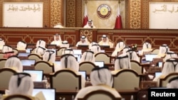 FILE - Members attend a session of the advisory Shura Council in Doha, Qatar, Oct. 26, 2021. 