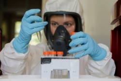 A scientist works inside a laboratory of the Gamaleya Research Institute of Epidemiology and Microbiology during the testing of a coronavirus vaccine, in Moscow, Russia, Aug. 6, 2020. (Russian Direct Investment Fund / Handout via Reuters)