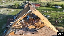 This handout photo taken on May 26, 2024, shows an aerial view of a home damaged by a tornado in Valley View, Texas. (Jacob Chambers via AFP)