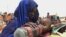 FILE - A mother quenches her malnourished child's thirst while waiting for food handouts at a health center in drought-stricken remote Somali region of Eastern Ethiopia, also known as the Ogaden, July 2011.