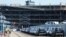 Cars readied for export are parked next to a vehicle storage facility on the dockside at the ABP port in Southampton, Britain, Aug. 16, 2017. 
