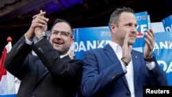 Christian Hafenecker and Michael Schnedlitz, secretaries-general of the Freedom Party (FPOe) react to the first exit polls during the general election, in Vienna, Austria, Sept. 29, 2024.