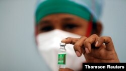 FILE PHOTO: A nurse displays a vial of COVISHIELD, the AstraZeneca COVID-19 vaccine manufactured by Serum Institute of India, in Mumbai, Feb 2, 2021.