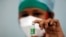 FILE PHOTO: A nurse displays a vial of COVISHIELD, the AstraZeneca COVID-19 vaccine manufactured by Serum Institute of India, in Mumbai