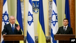 Israeli Prime Minister Benjamin Netanyahu, left, gestures while speaking during his and Ukrainian President Volodymyr Zelenskiy, joint news conference following their talks in Kyiv, Ukraine, Aug 19, 2019. 