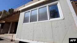 Bullet holes are seen in the guard post in front of the South Korean Embassy following an attack by gunmen on the embassy compound in the Libyan capital, Tripoli, April 12, 2015.