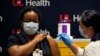 LaShawn Scott, a nurse at University of Louisville Hospital, is inoculated with the Pfizer coronavirus disease (COVID-19) vaccine at The University of Louisville Hospital in Louisville, Kentucky, December 14, 2020.