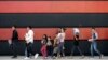 Immigrant families walk along a sidewalk on their way to a respite center after they were processed and released by U.S. Customs and Border Protection, June 24, 2018, in McAllen, Texas. 